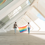 Una pareja sosteniendo una bandera de arcoíris